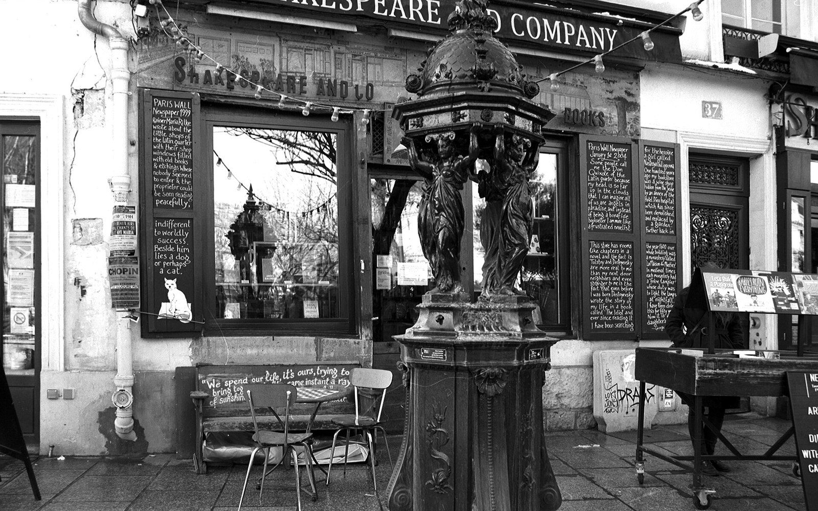 A Wallace fountain stands outside the Shakespeare and Company bookshop storefront